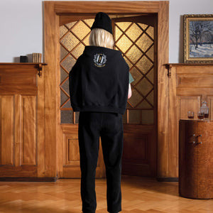 Woman view from the back, standing with a black Alpime Emblem Crewneck Sweatshirt on her shoulders