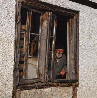 Old farmer at window