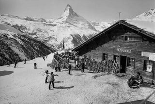 Matterhorn in Switzerland with skiers and chalet